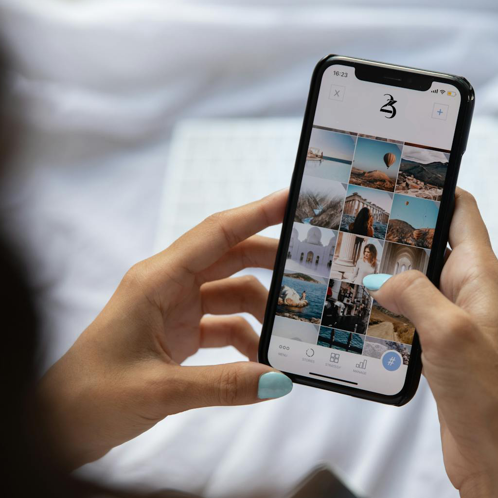 Person holding a smartphone with a social media feed displayed.