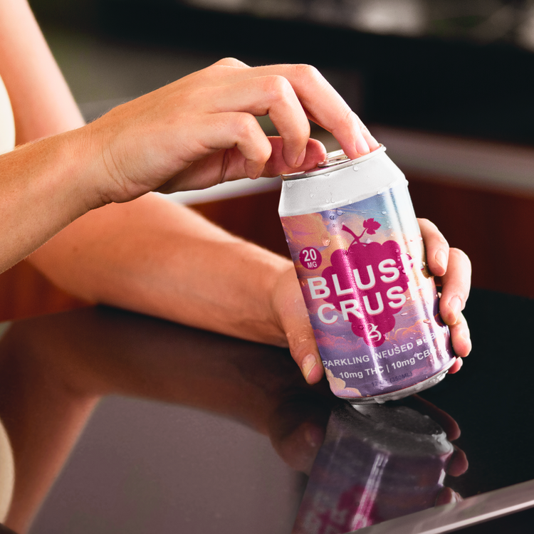 Person opening a can of BLUSH CRUSH.