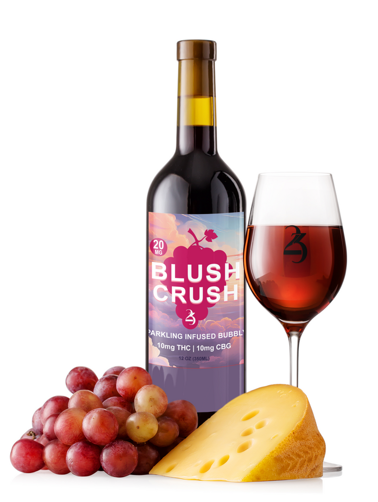 Bottle of 'Blush Crush' wine with a glass of wine, grapes, and cheese on a white background