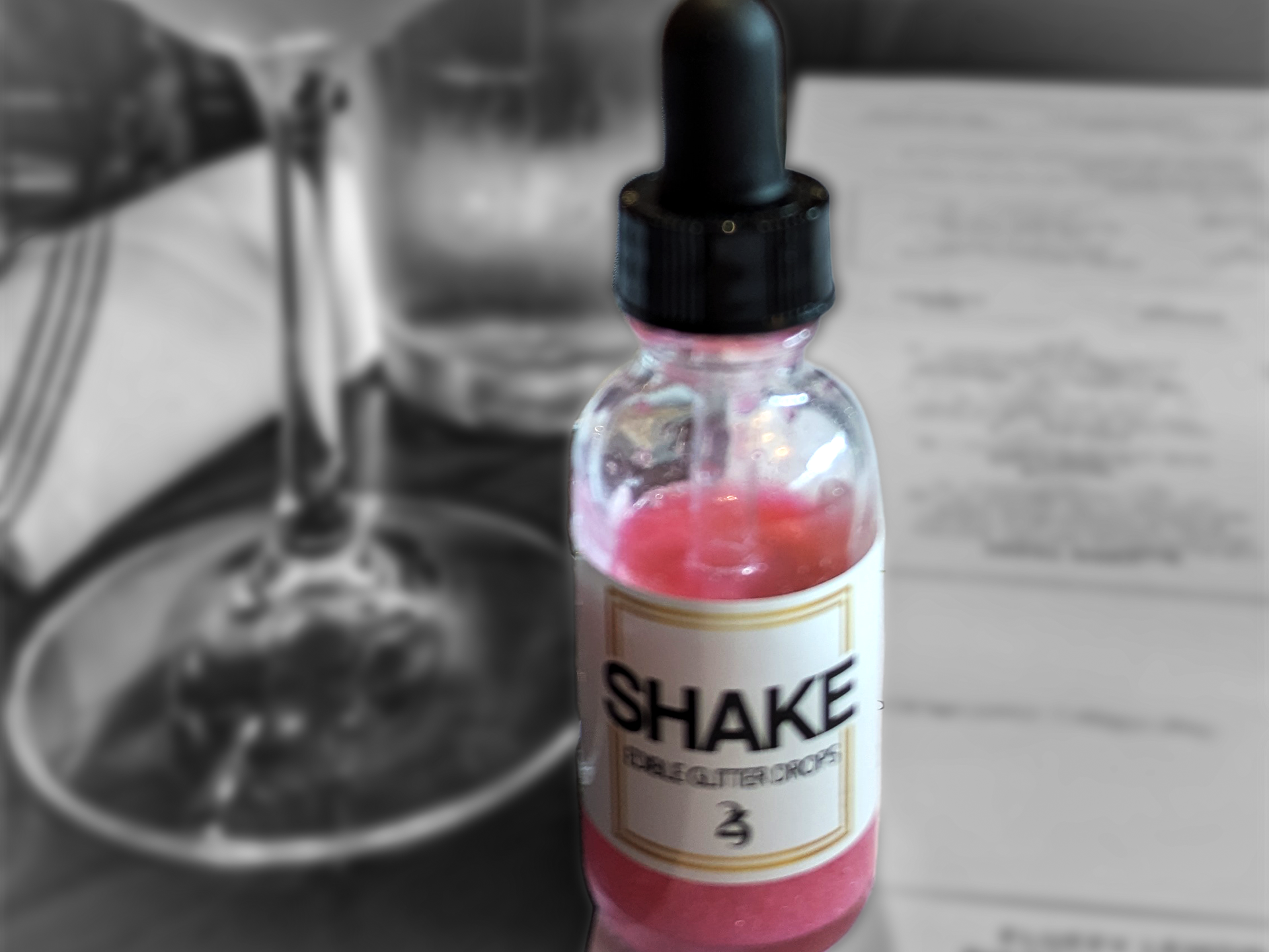 Bottle of 'SHAKE' with a dropper on a blurred background
