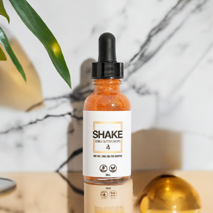 SHAKE with a plant in the background.