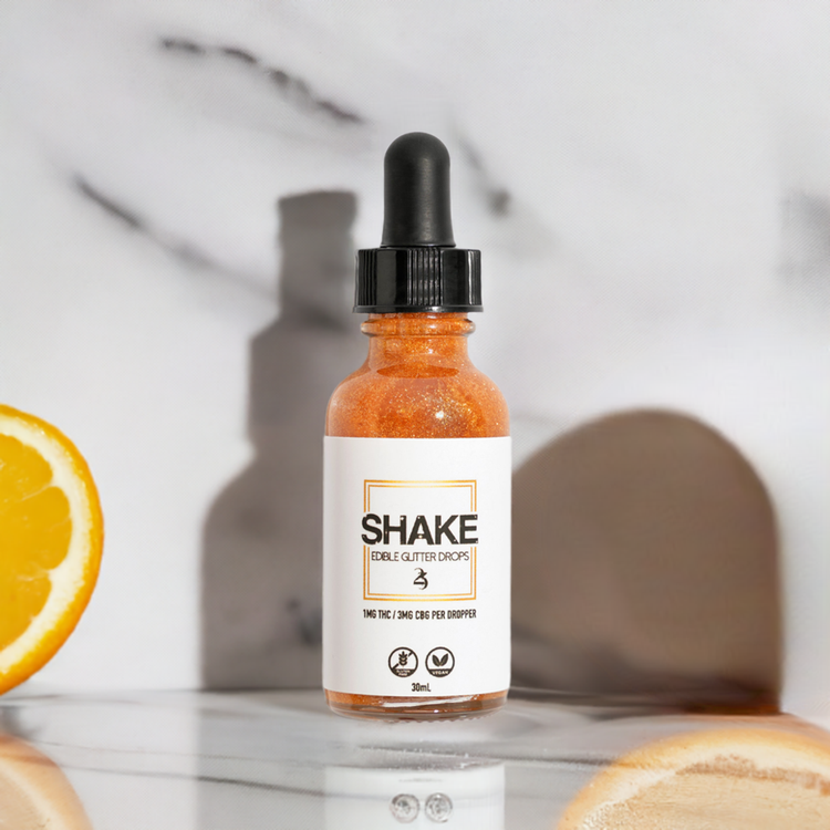 SHAKE 24k gold bottle on a hard surface.