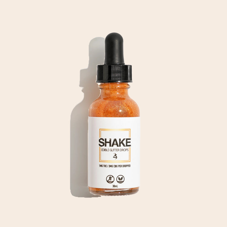 Bottle of 'SHAKE' with a dropper on a beige background