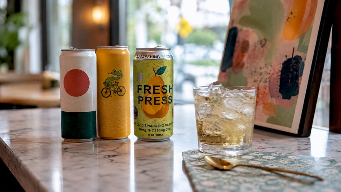 CBD beverage cans on kitchen counter with glass