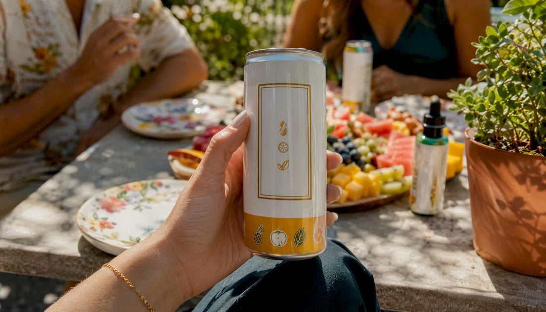 Hand holding hemp beverage can with label close-up