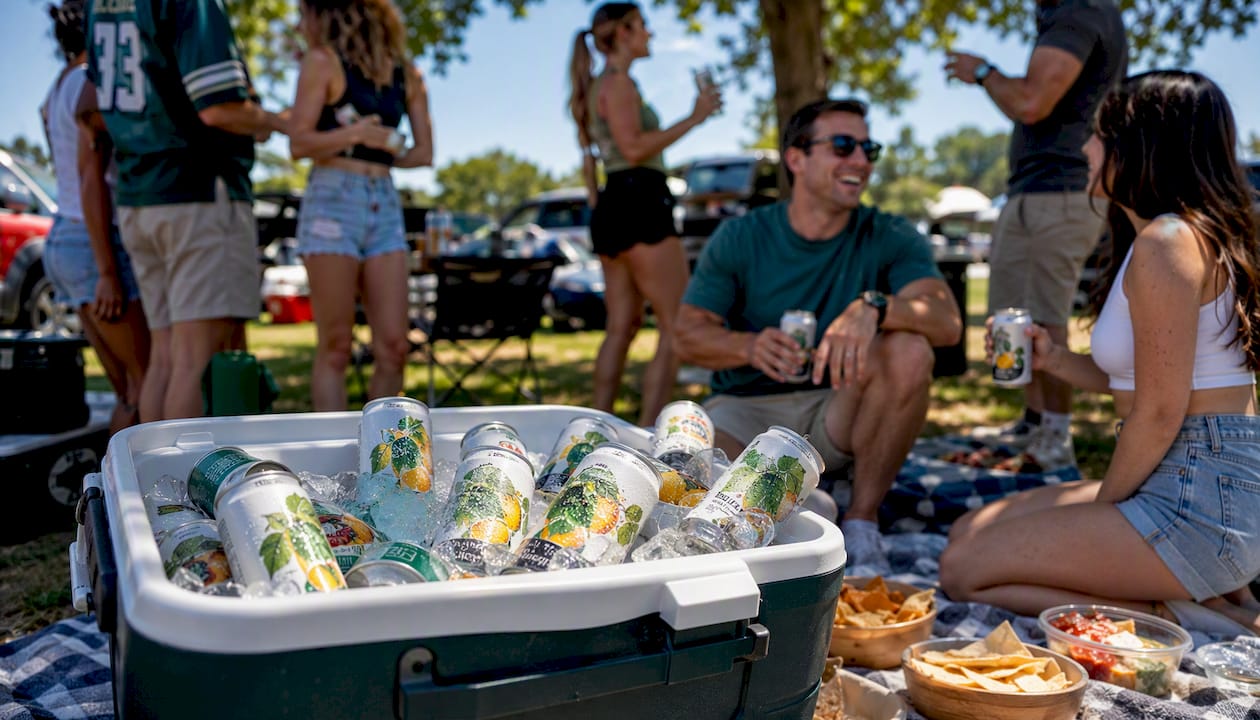 Cooler filled with THC drink cans at tailgate