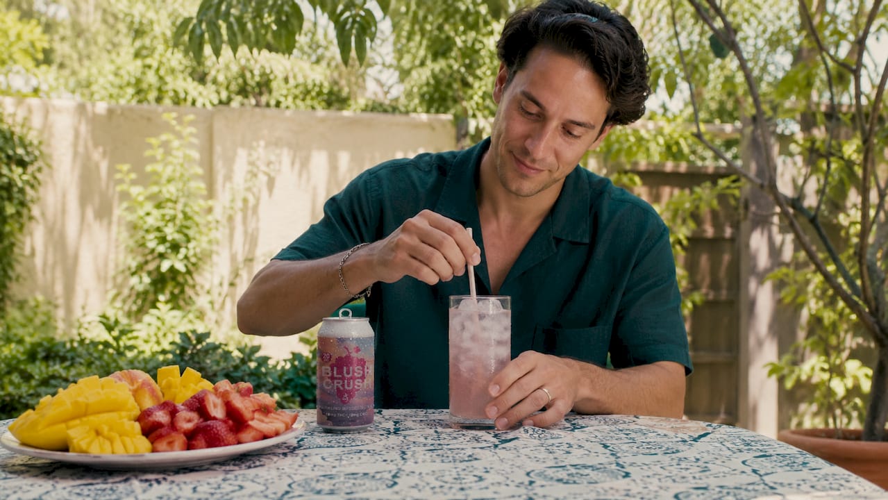 Person setting timer beside hemp beverage can