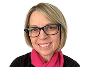 Person wearing glasses and a pink scarf with a plain background