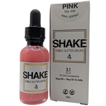 Bottle of pink Cosmo 'SHAKE' edible THC infused glitter drops with packaging on a white background
